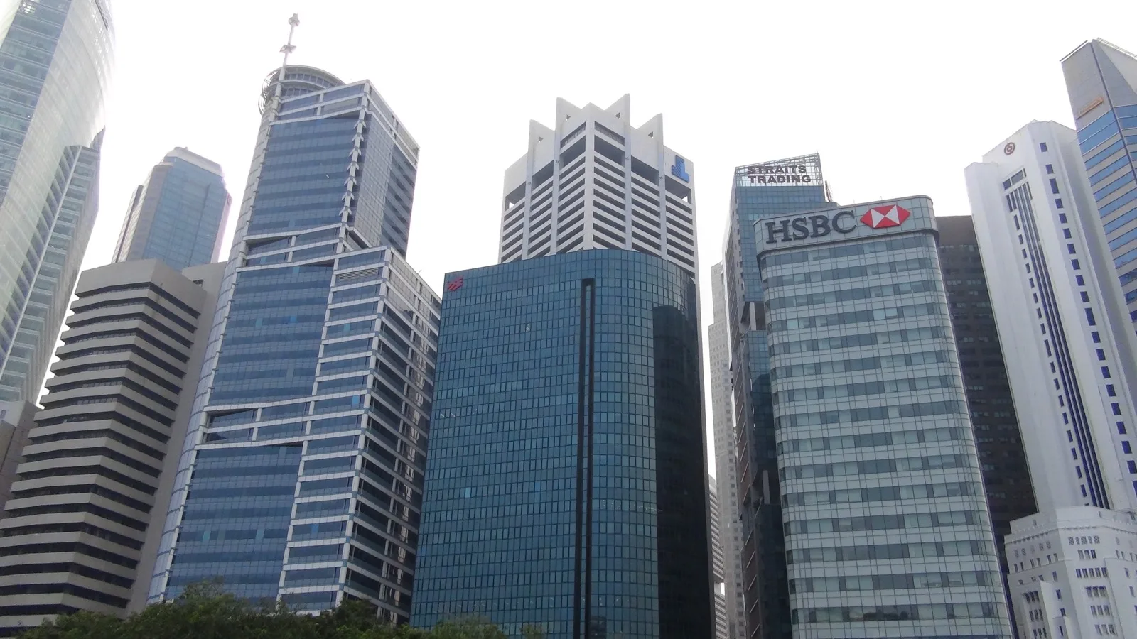 Modern office towers and mixed-use real estate skyline in Singapore's central business district under daytime sky