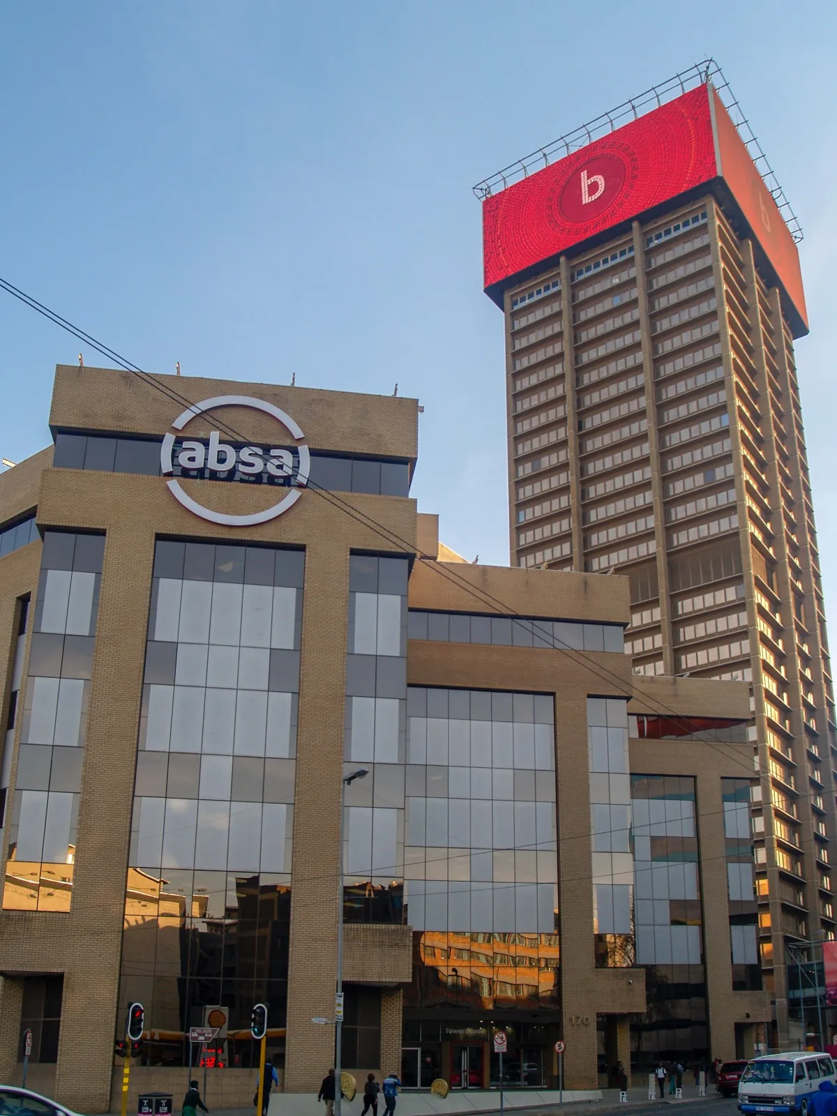 Exterior view of the Johannesburg Stock Exchange building with its glass facade and signage, illustrating a general explainer on green bond listing standards.