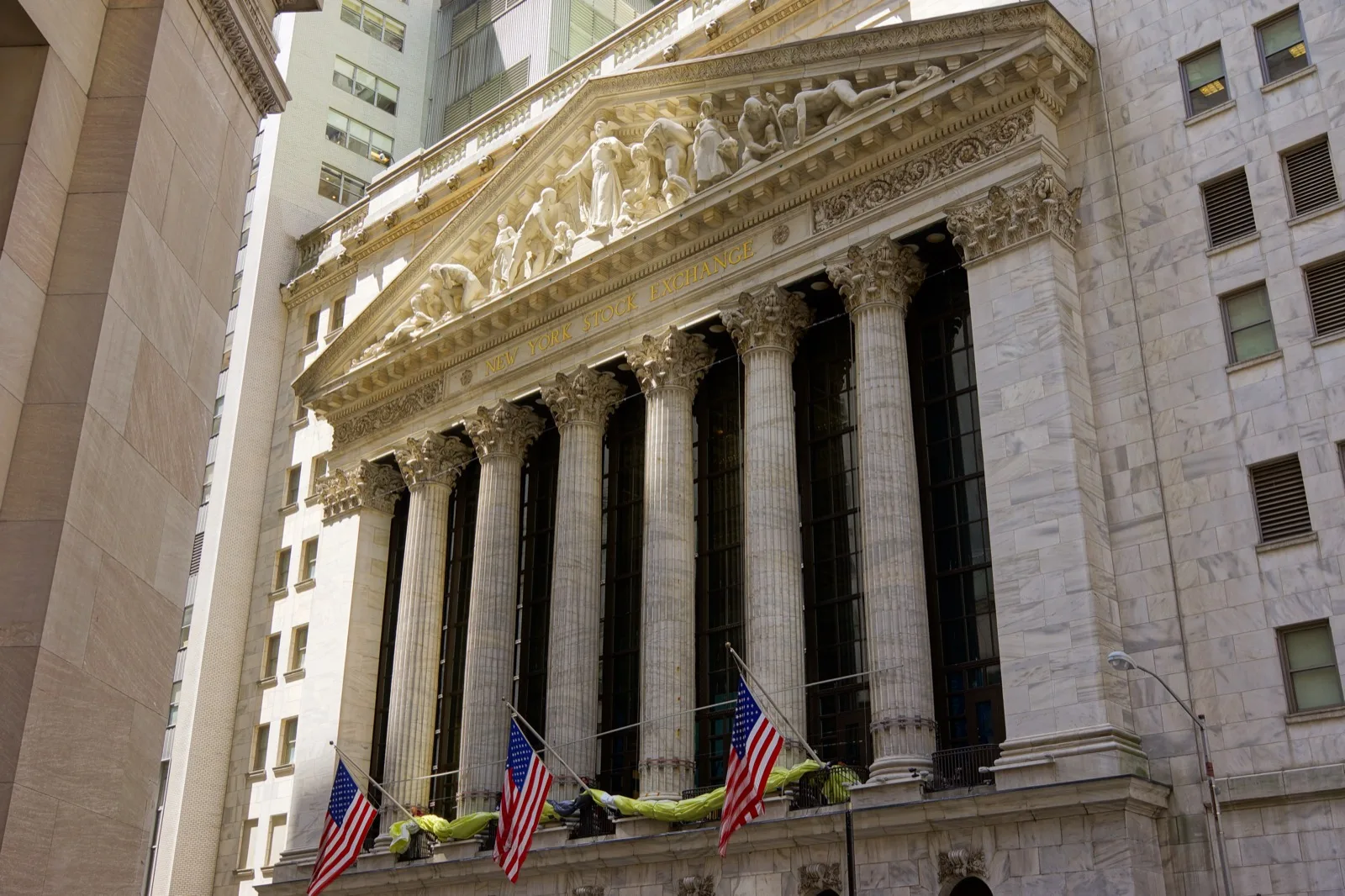 A stock exchange trading floor display showing real-time bid and ask prices scrolling across an electronic ticker board