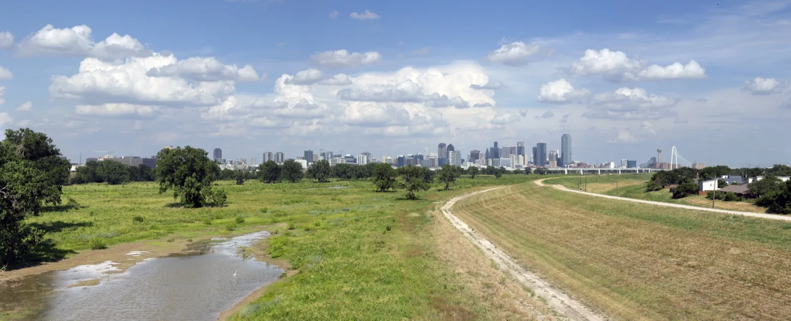 Dallas skyline and a Trinity River levee from North Hampton Inwood road